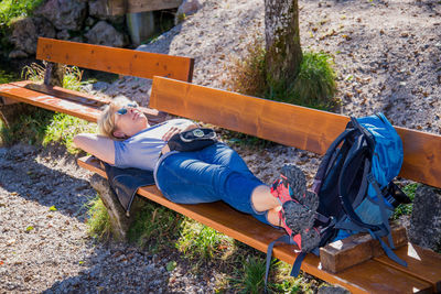 Woman lying on bench