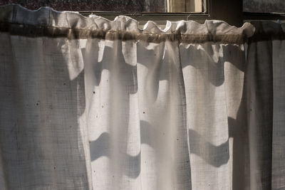 Close-up of curtain hanging on window