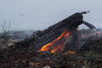 Panoramic view of bonfire on land against sky