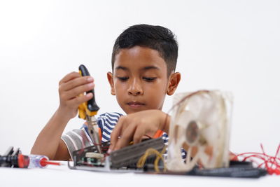 Portrait of boy playing with toy car