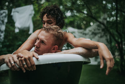 Couple in bathtub outdoors