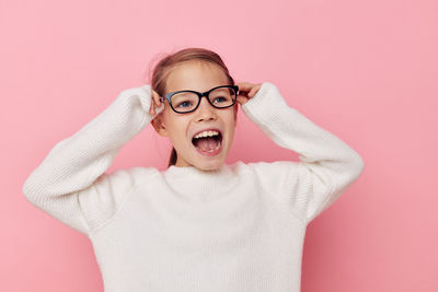 Girl screaming against pink background
