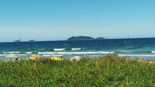 Scenic view of sea against clear blue sky
