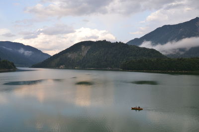 Scenic view of lake and mountains against sky