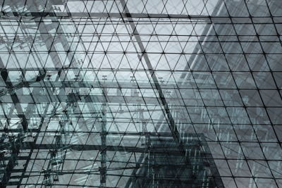 Double exposure of modern building against sky