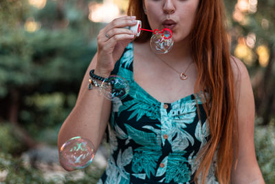 Midsection of a woman drinking water