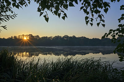 Scenic view of lake against sky during sunset