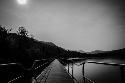 Empty jetty leading to calm lake