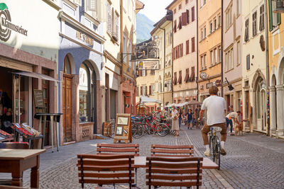 People walking on street amidst buildings in city