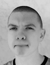 Black and white portrait of a teenage boy making a funny face 