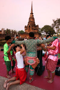 Group of people in temple outside building