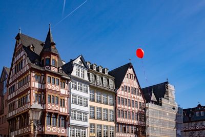 Low angle view of buildings against blue sky