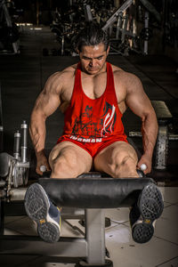 Portrait of young man exercising at gym