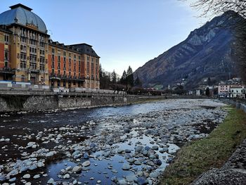 River amidst buildings against sky