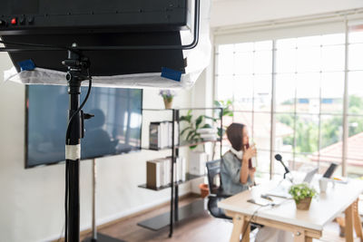 Defocused image of woman blogging at office