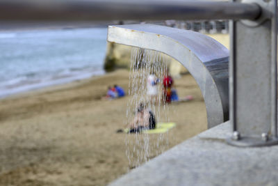 Close-up of water wheel on beach