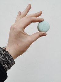 Close-up of hand holding over white background