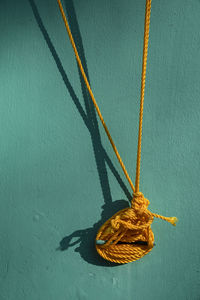 High angle view of rope tied on wall
