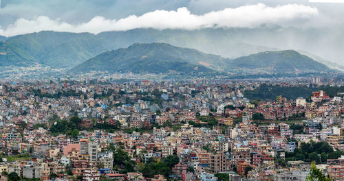 A view of the population density in city of kathmandu under a stormy sky.