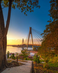 Bridge against clear blue sky during sunset