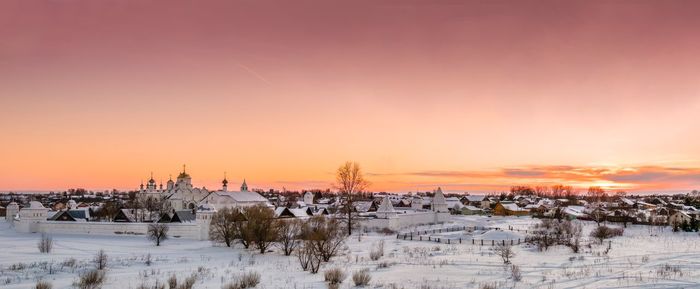 Scenic view of snow field against sky during sunset