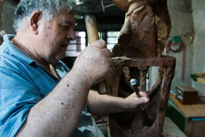 Senior man working at workshop