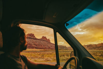 Man seen through car window