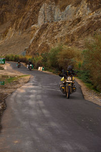 People riding motorcycle on road