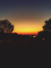 Silhouette trees against sky during sunset
