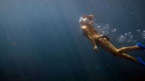 Young woman swimming in sea