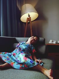 Girl relaxing on sofa at home