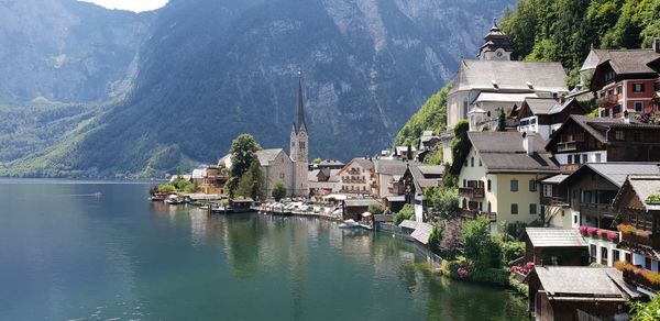 Buildings by town against mountains