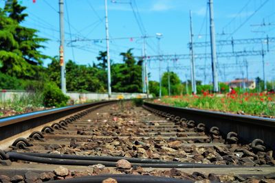 Surface level shot of railroad track on field against sky