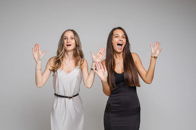 Young woman standing against white background