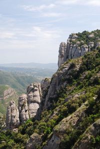 Rock formations on landscape against sky