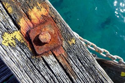 Close-up of rusty metal on wood