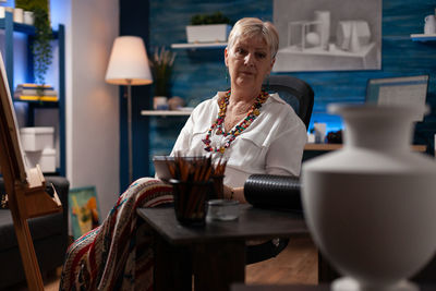 Portrait o woman sitting in workshop