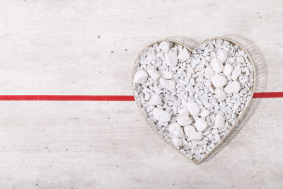 Directly above shot of heart shape on white table