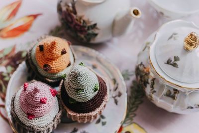 High angle view of artificial knitted cupcakes on table