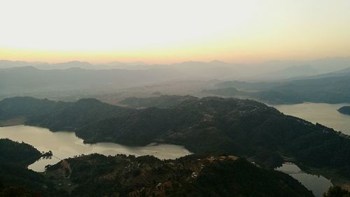 Scenic view of mountains against sky at sunset