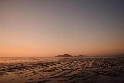 Scenic view of desert against sky during sunset