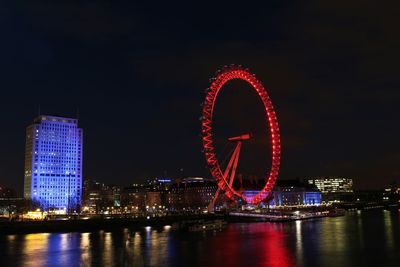 Illuminated ferris wheel at night