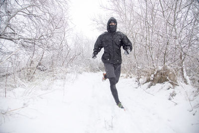 Full length of man on snow covered field