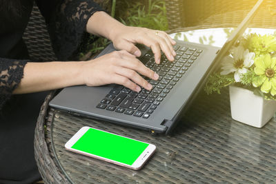 High angle view of woman using laptop on table