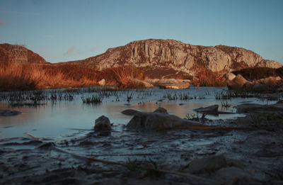 Scenic view of lake and mountains against sky