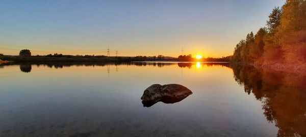 Scenic view of lake against sky during sunset