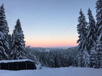 Scenic view of snow covered landscape against clear sky