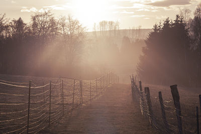 Scenic view of landscape against sky during foggy weather