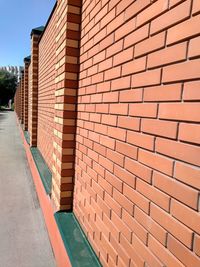 View of brick wall with building in background