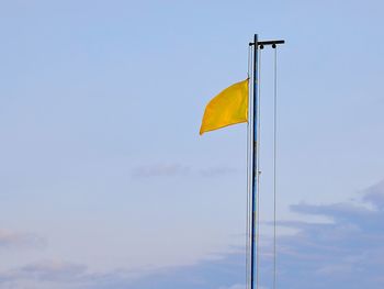 Low angle view of flag against sky